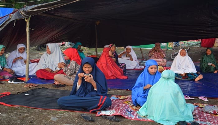 Muslimah di Pengungsian Palu tengah menikmati sarapan pagi di posko pengungsian Lapangan Mister, Kelurahan Tipo, Palu, Sulawesi Tengah. Foto: Istimewa